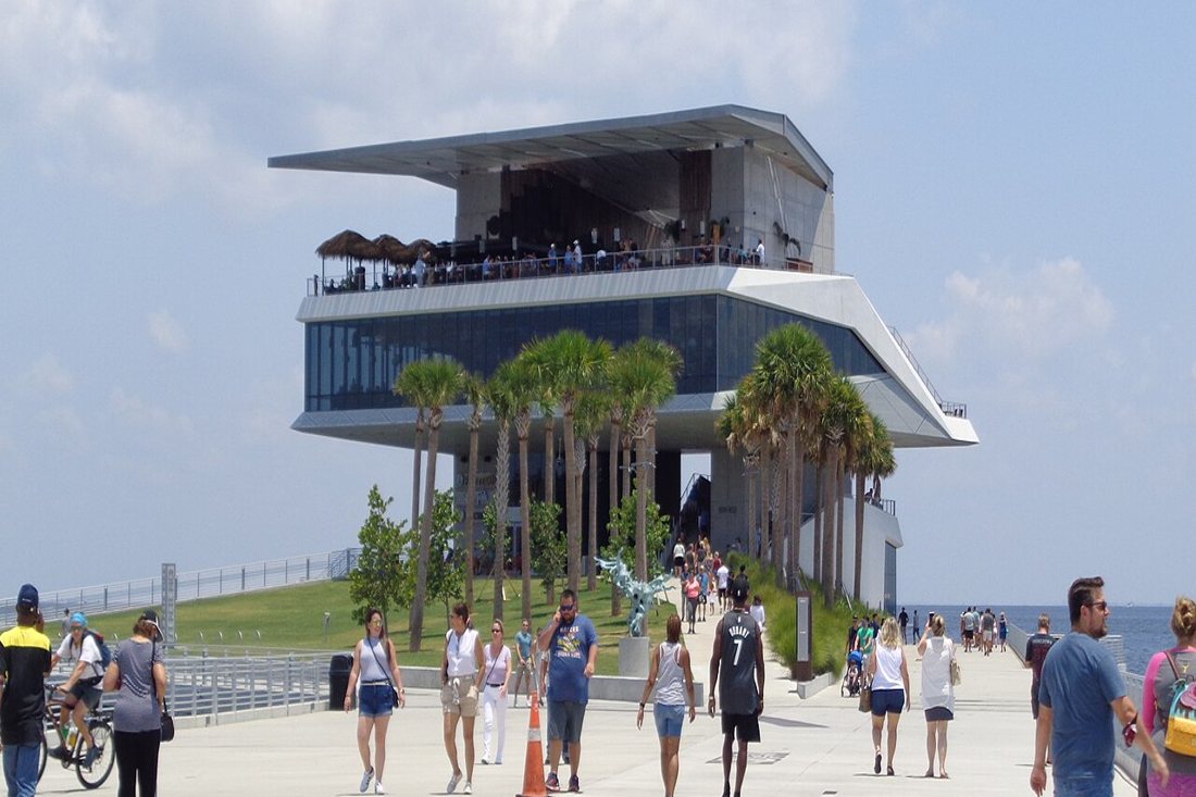 The St. Pete Pier head building framed by palm trees
